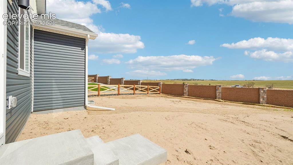 Image 42 of 47: Exterior featuring horizontal siding, white window trim, and concrete steps