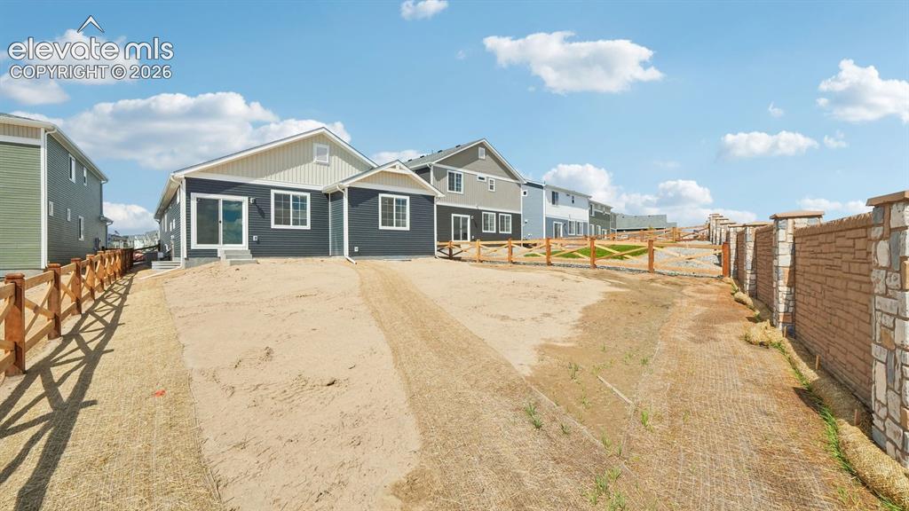Image 43 of 47: Newly constructed residence featuring a dark gray exterior, white window tr