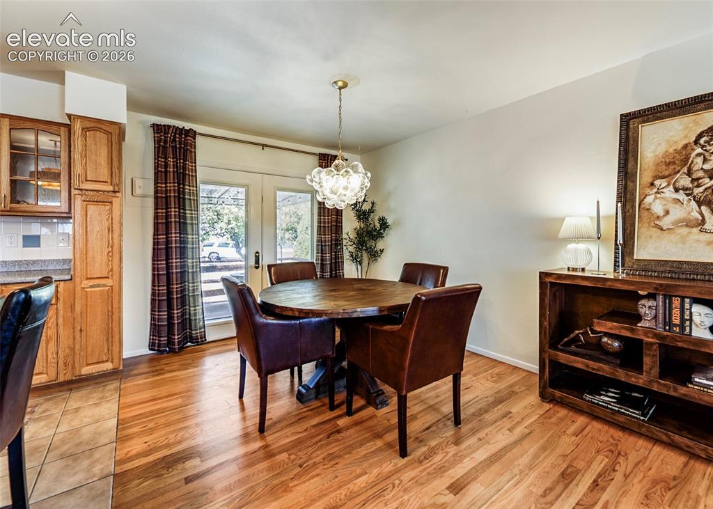 Image 13 of 48: Wood-finish flooring, glass-paneled French doors, and a decorative ceiling 