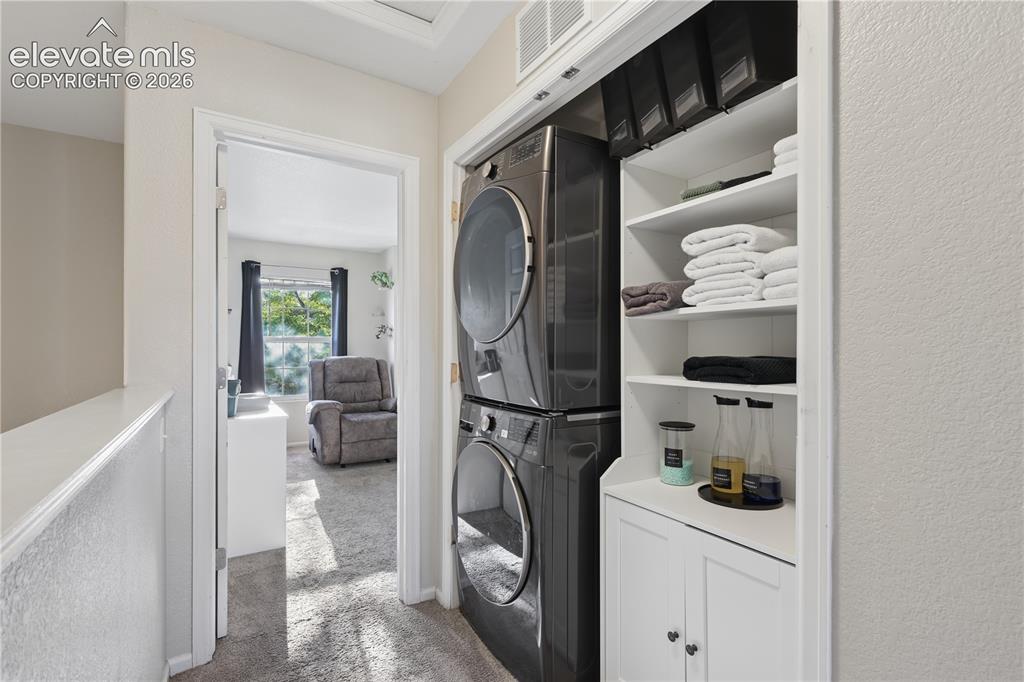 Image 10 of 26: Upstairs laundry located between the two bedrooms