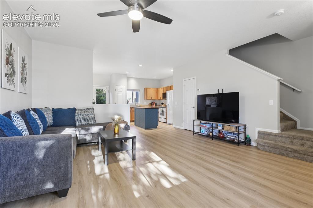 Image 11 of 26: Main living space with 1/2 bath located underneath the stairs