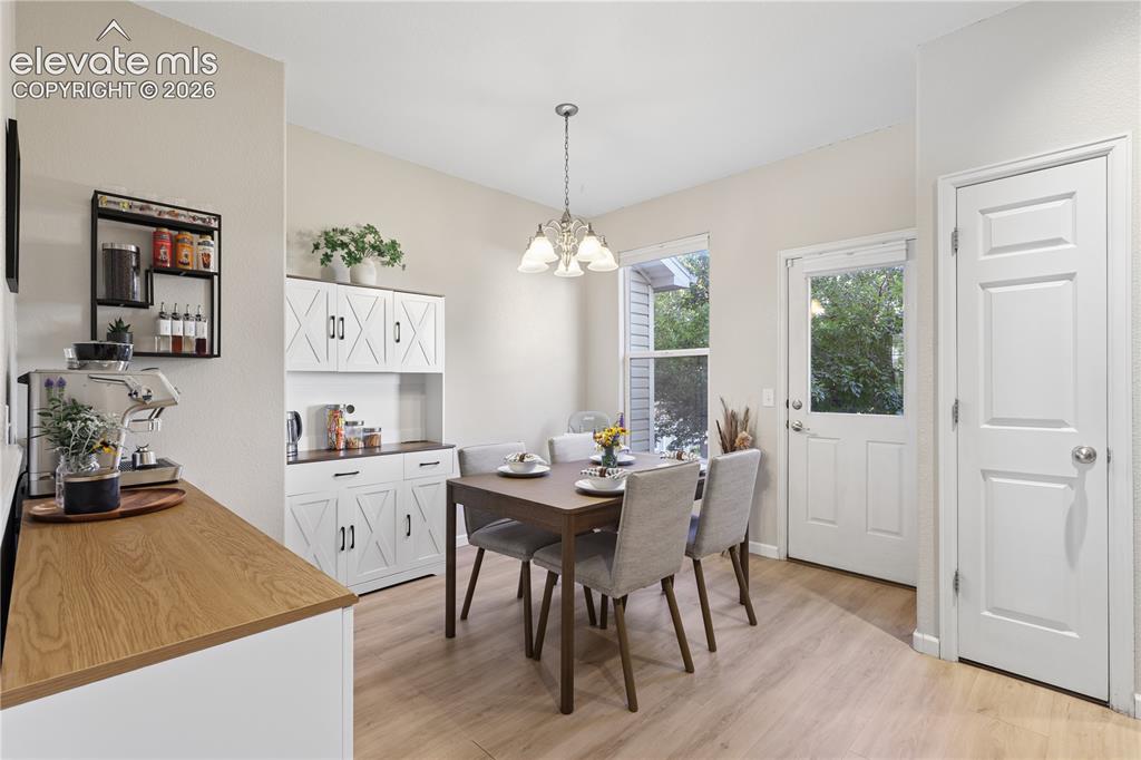 Image 4 of 26: Dining area with access to common space behind the unit