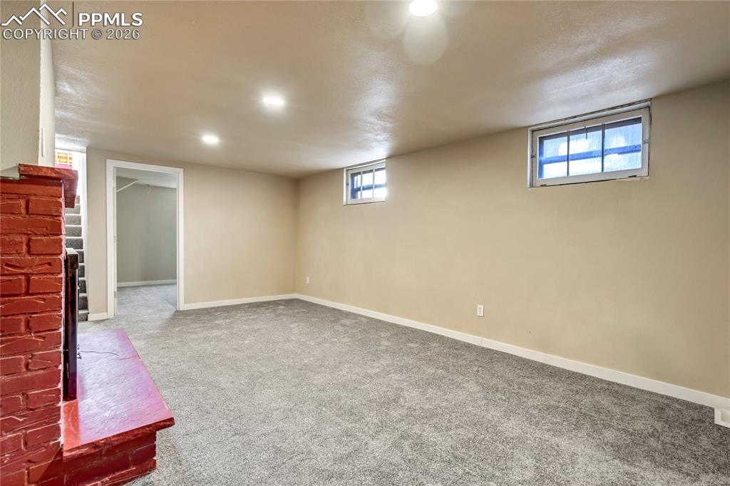 Image 19 of 28: Family room with wood burning fireplace.