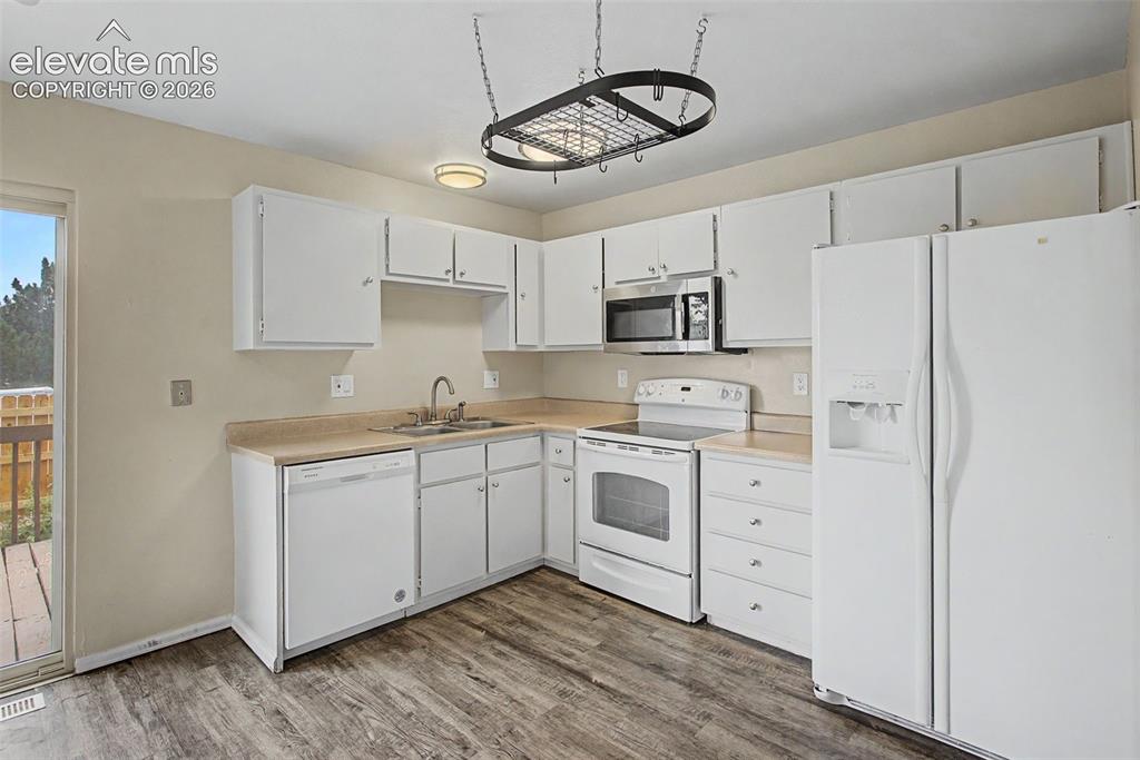 Image 11 of 26: The Kitchen is fully equipped with a Refrigerator, Range, Microwave and Dis