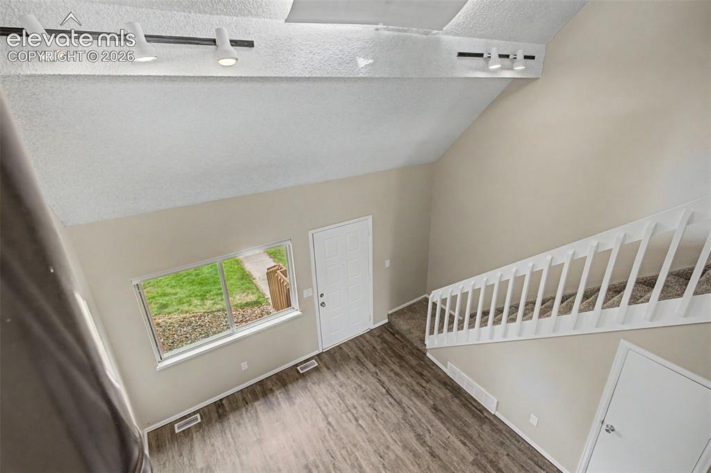 Image 17 of 26: Vaulted ceilings and large windows provide depth allow for the home to feel