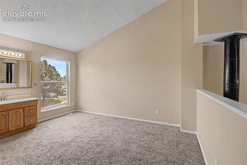 Image 19 of 26: The naturally lit bedroom has its own full bathroom!