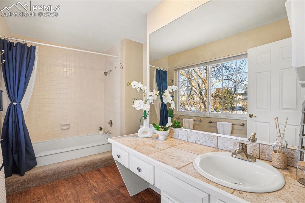 Image 18 of 29: Spacious primary bedroom with a full adjoining bath, abundant natural light