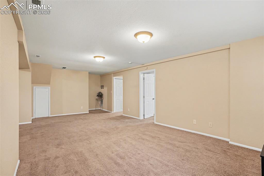 Image 21 of 29: Expansive basement family room, ideal for game nights or movie marathons