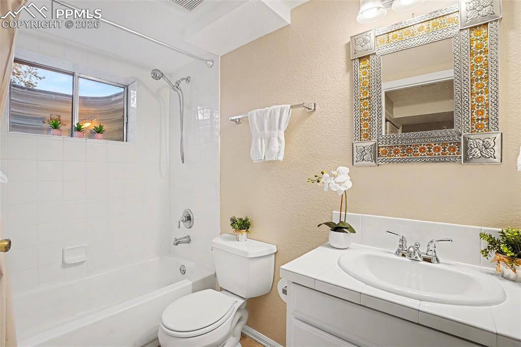 Image 23 of 29: Basement bathroom conveniently set up as a Jack-and-Jill, perfect for guest