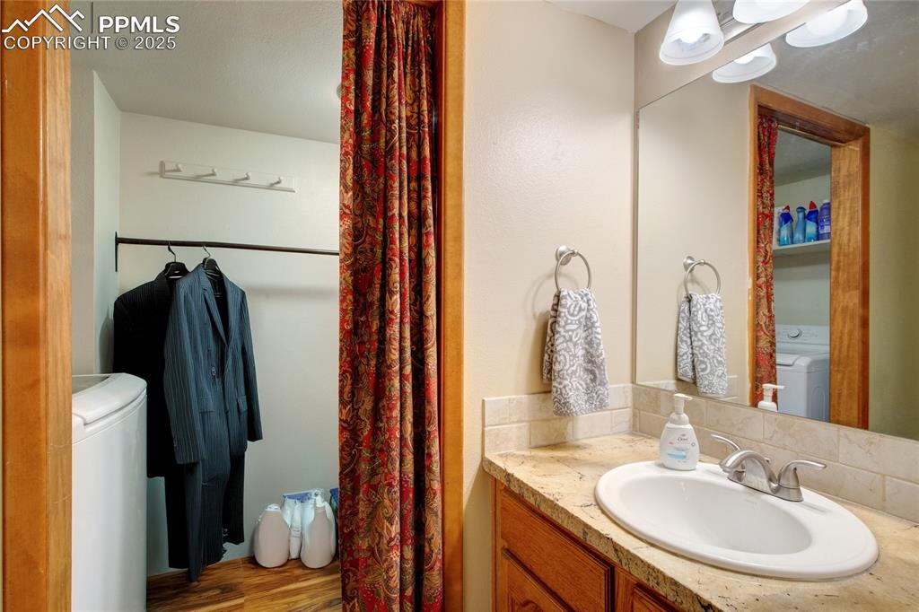 Image 16 of 38: Main level half bath with attached laundry room