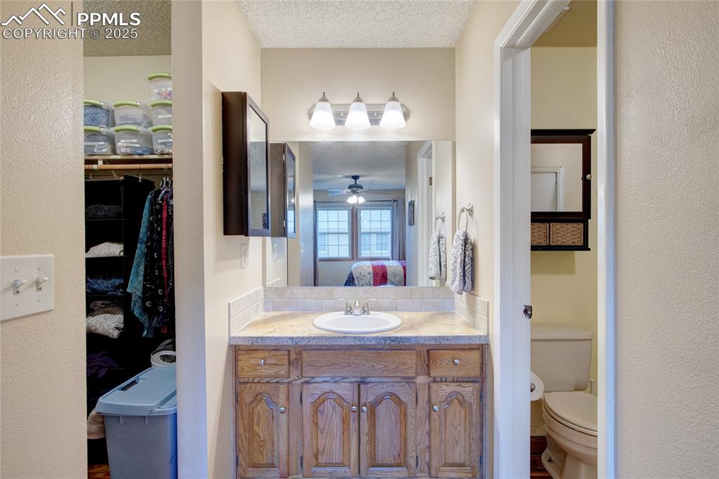 Image 24 of 38: Primary bath suite with attached walk in closet