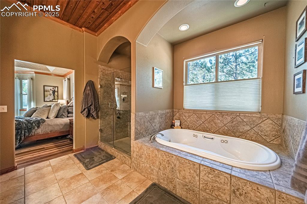 Image 19 of 50: Full bathroom featuring a stall shower, a bath, healthy amount of natural l