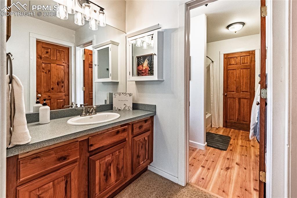 Image 24 of 50: Full bath featuring shower / bathtub combination with curtain and vanity