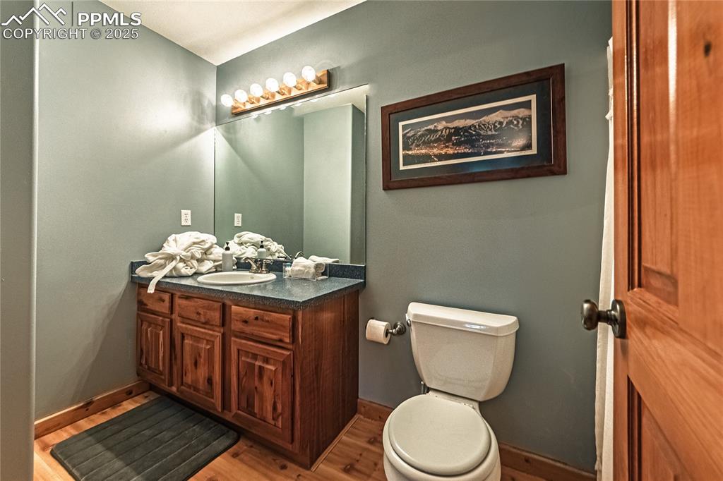 Image 35 of 50: Half bath with vanity and light wood-type flooring