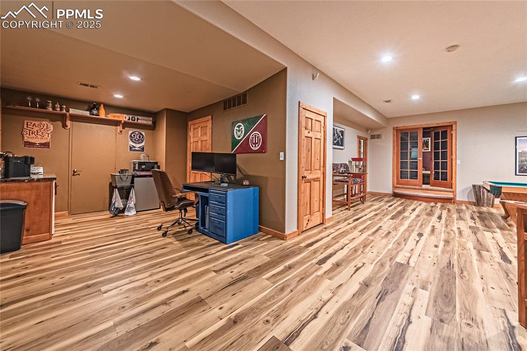 Image 36 of 50: Large Game Room, featuring a wet bar, billiards, light wood-type flooring,