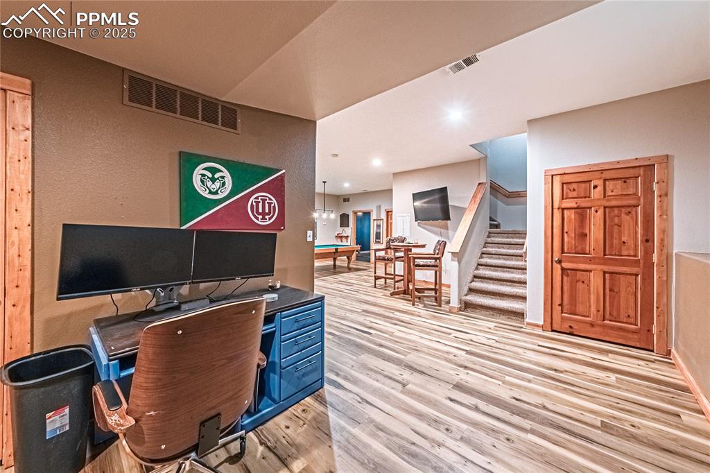 Image 38 of 50: Game Room with area for another office or video game station, light wood-st