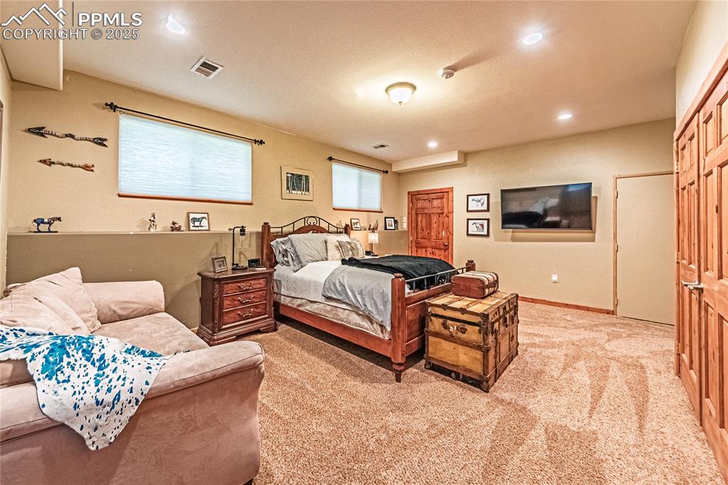 Image 43 of 50: Bedroom featuring light carpet and recessed lighting