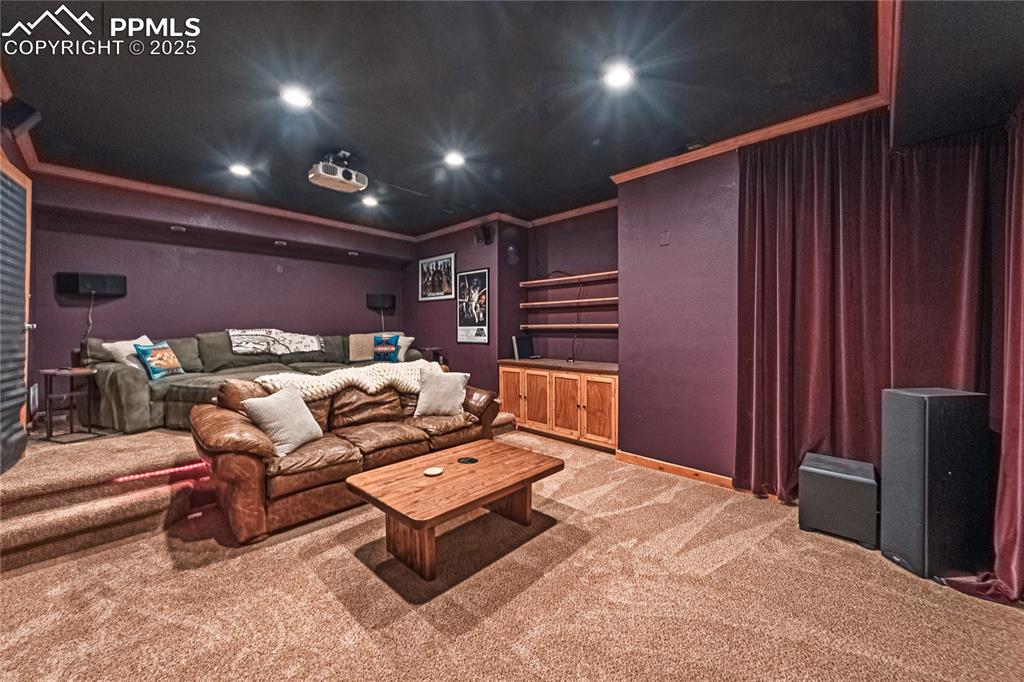 Image 46 of 50: Cinema room featuring light colored carpet, recessed lighting, and ornament