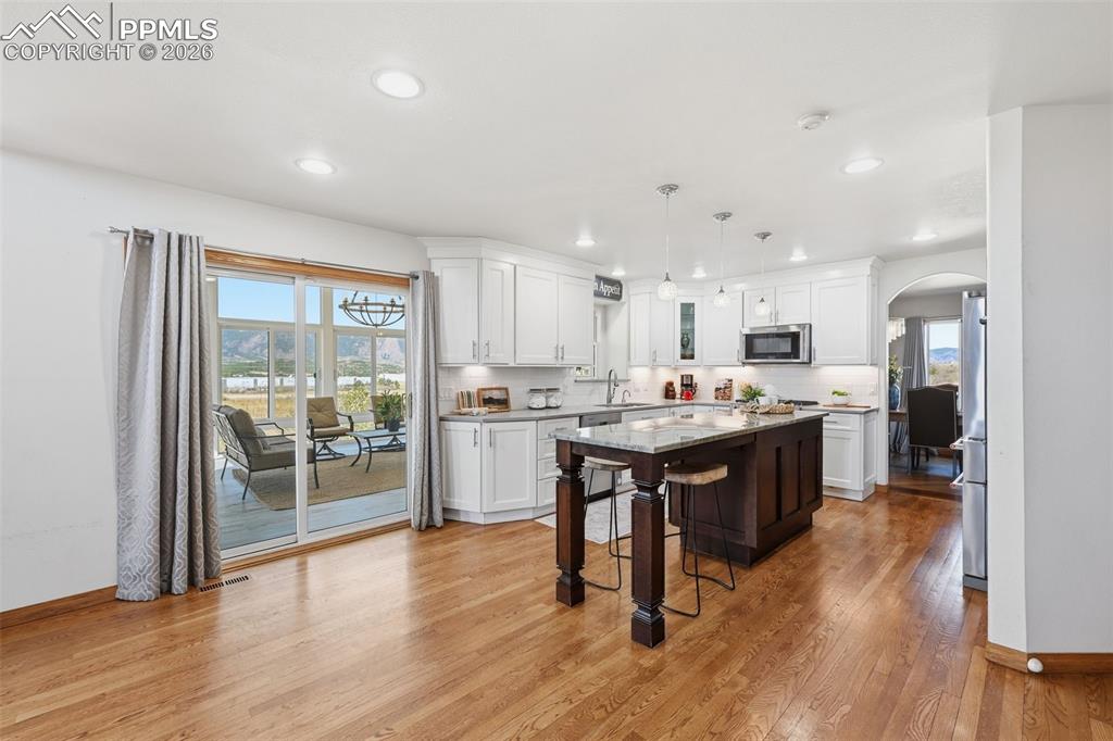 Image 22 of 50: Kitchen flows to the huge sunroom.