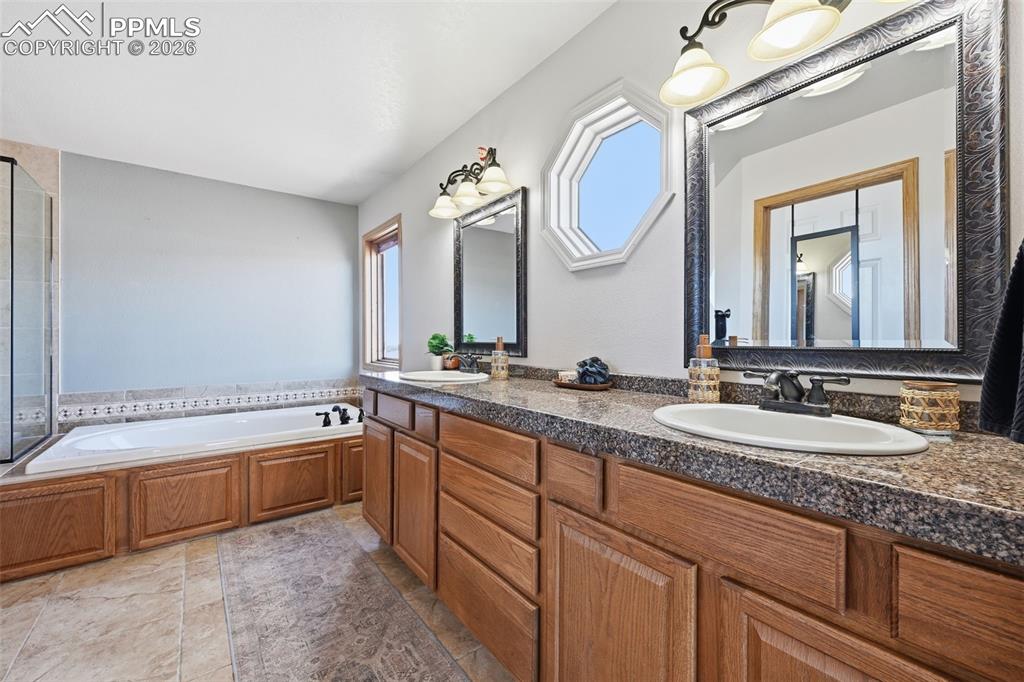 Image 37 of 50: Bath with soaking tub. 