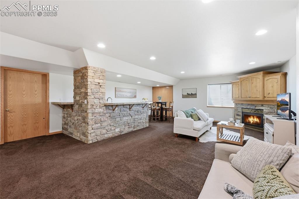 Image 45 of 50: Huge stone framed wetbar. 