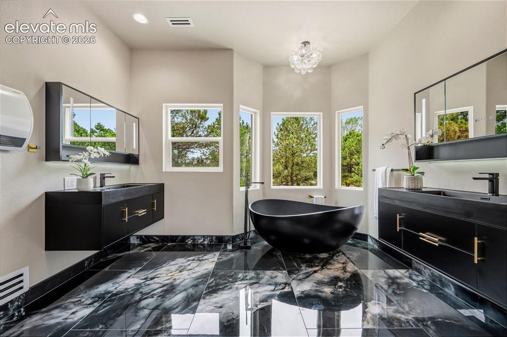 Image 18 of 46: Heated marble floors with luxurious soaking tub