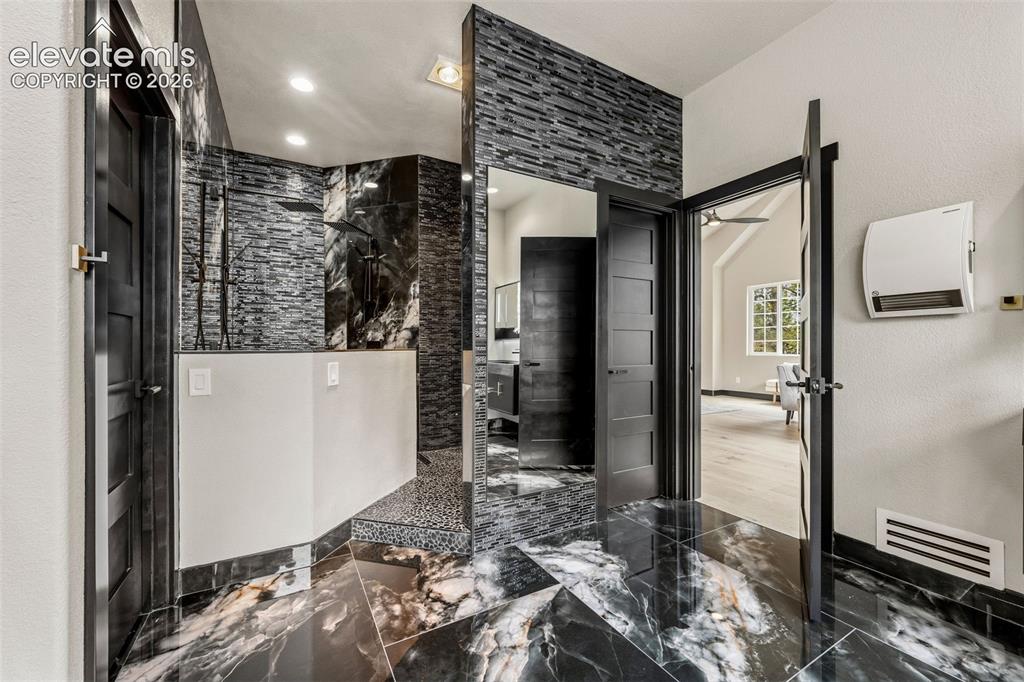 Image 19 of 46: Heated walk-in shower with dual rainfall showerheads
