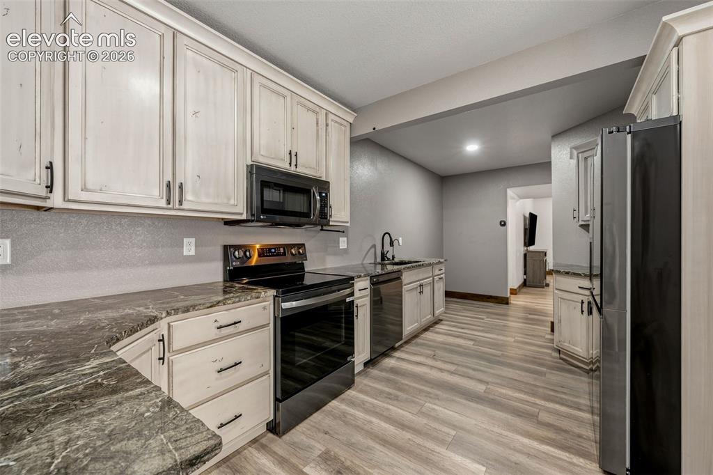 Image 32 of 46: Full second kitchen with walk-in pantry