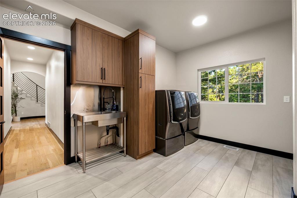 Image 35 of 46: Main level mudroom and laundry room (additional laundry on lower level)