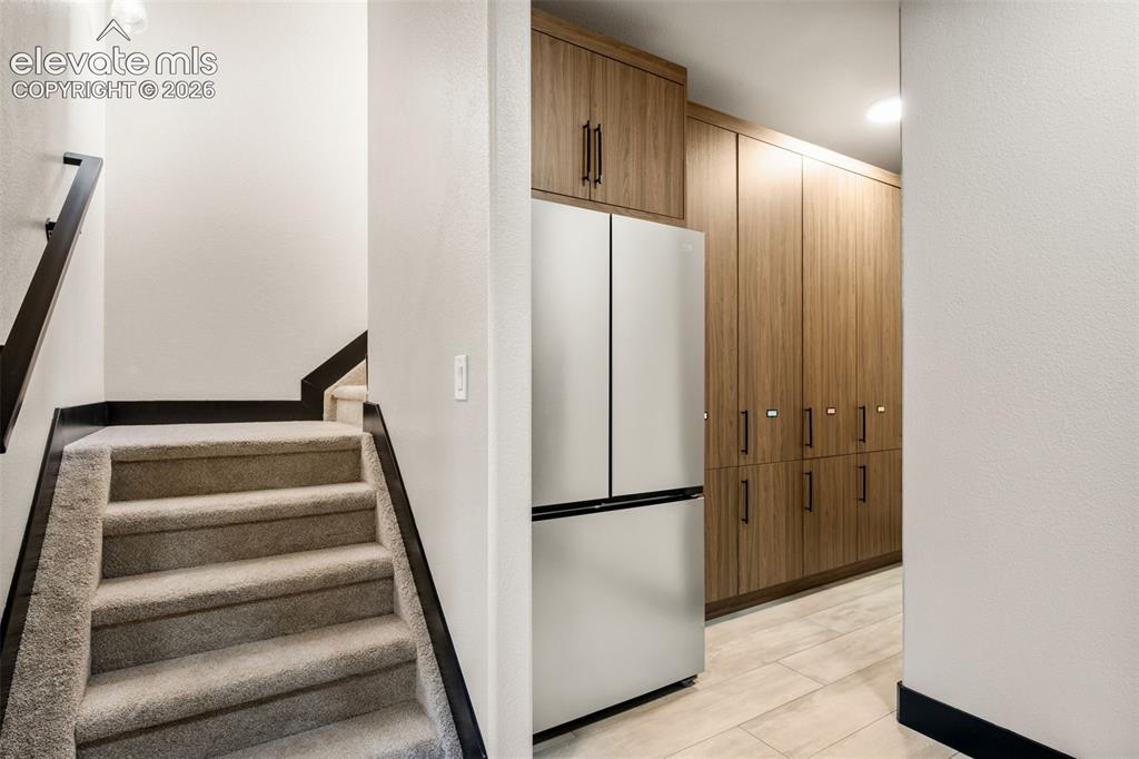 Image 36 of 46: Additional staircase to master bedroom. Large custom storage cabinets