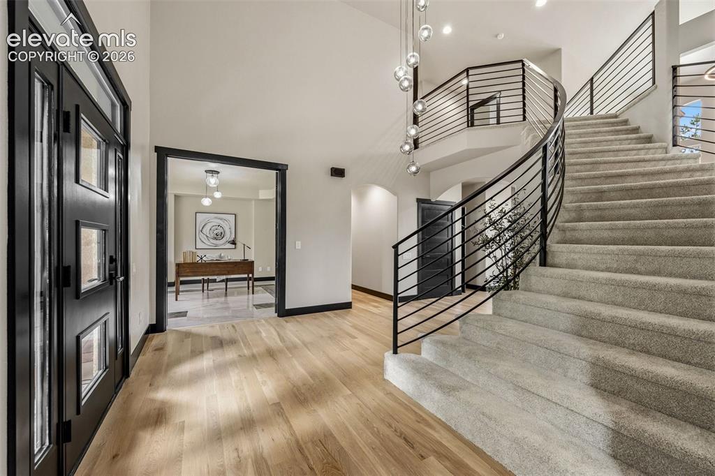Image 6 of 46: Curved staircase with custom steel handrail