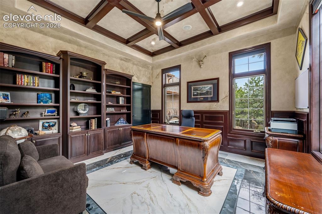 Image 7 of 46: Mahogany built-ins and coffered ceiling