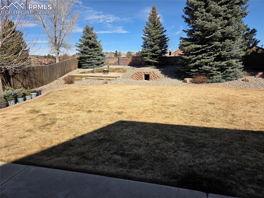 Image 15 of 38: View of fenced backyard