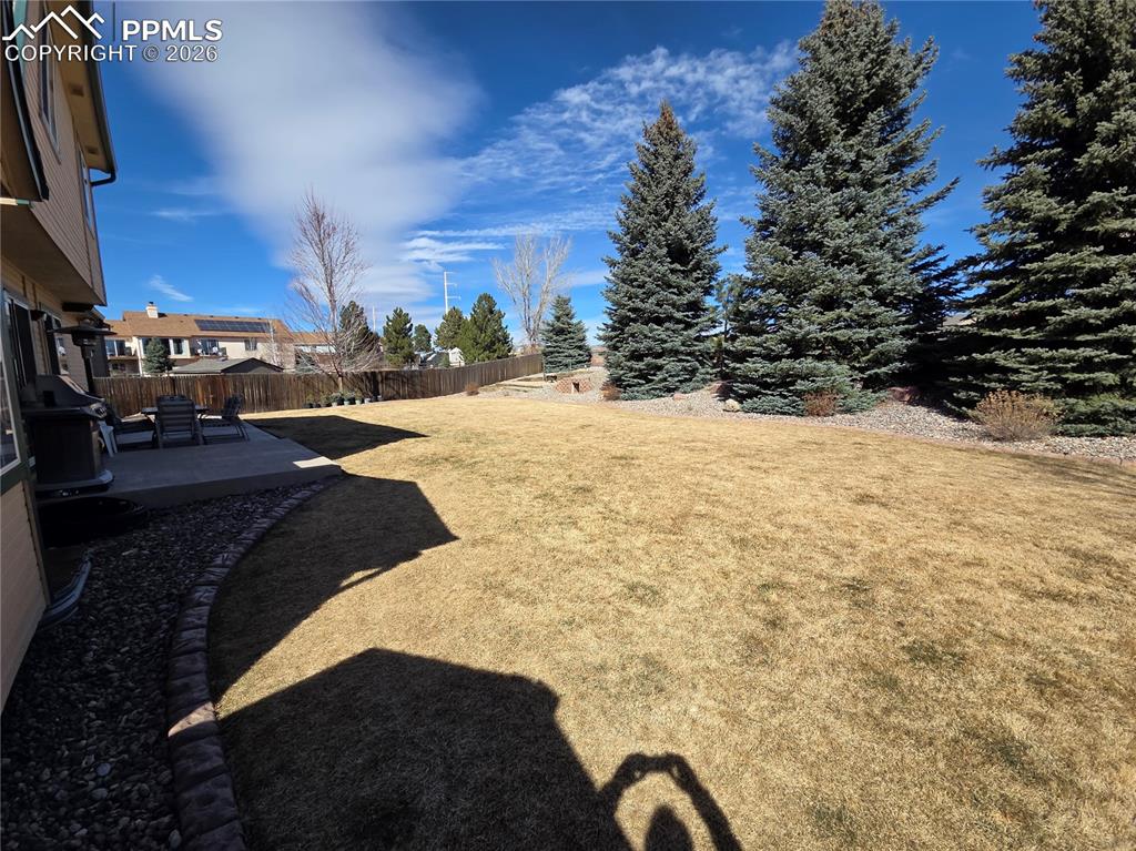 Image 17 of 38: Fenced backyard featuring a patio