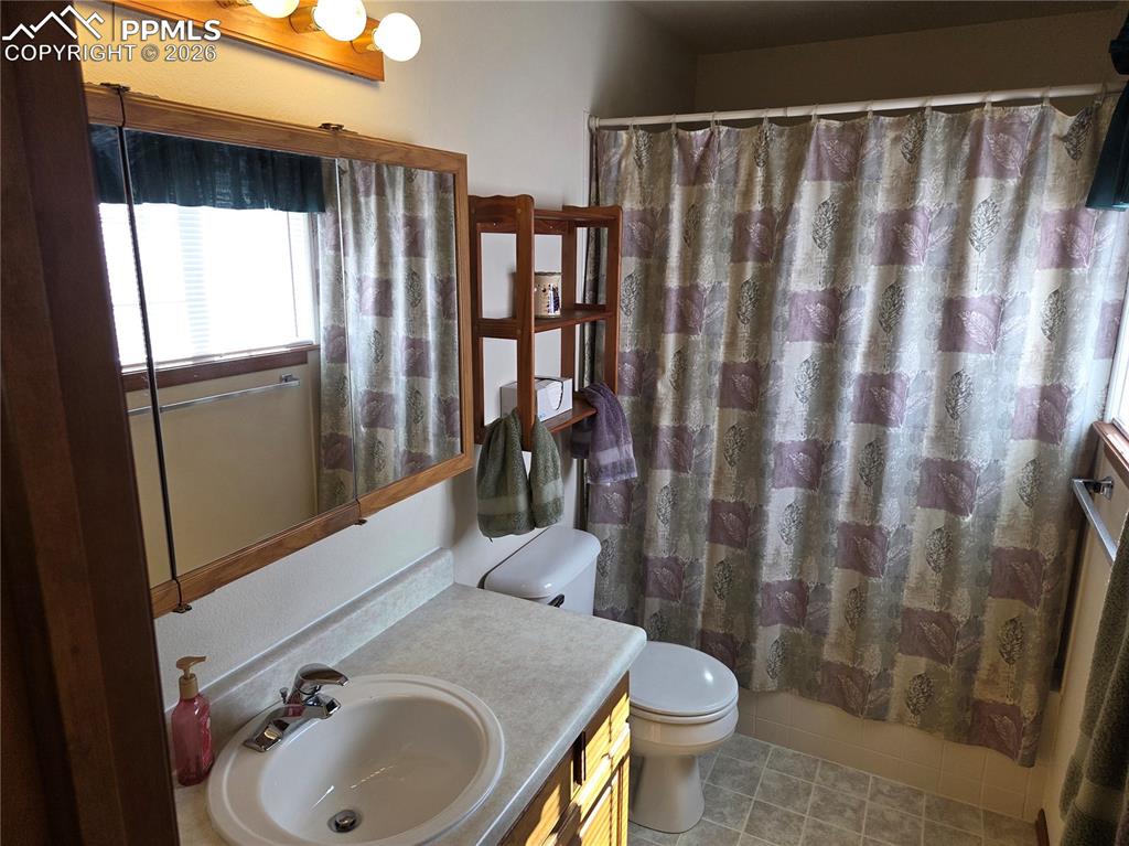 Image 22 of 38: Bathroom featuring vanity, a shower with curtain, and light tile patterned 
