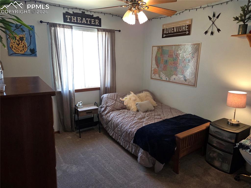 Image 23 of 38: Bedroom featuring dark carpet