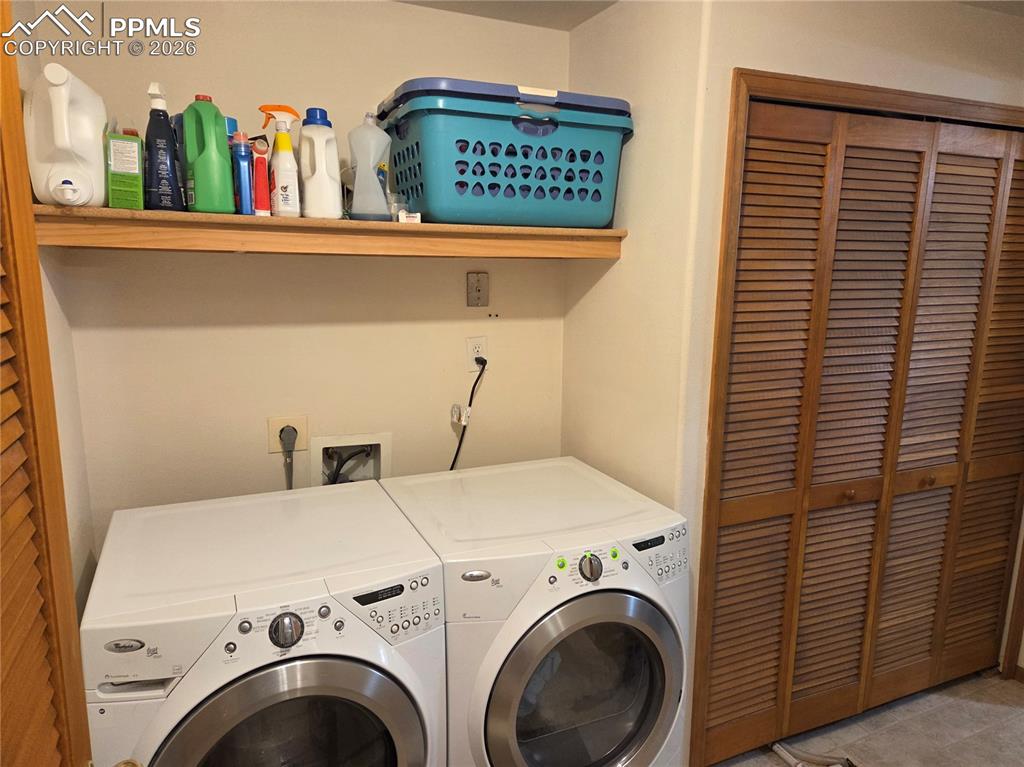 Image 30 of 38: Laundry area with washing machine and dryer