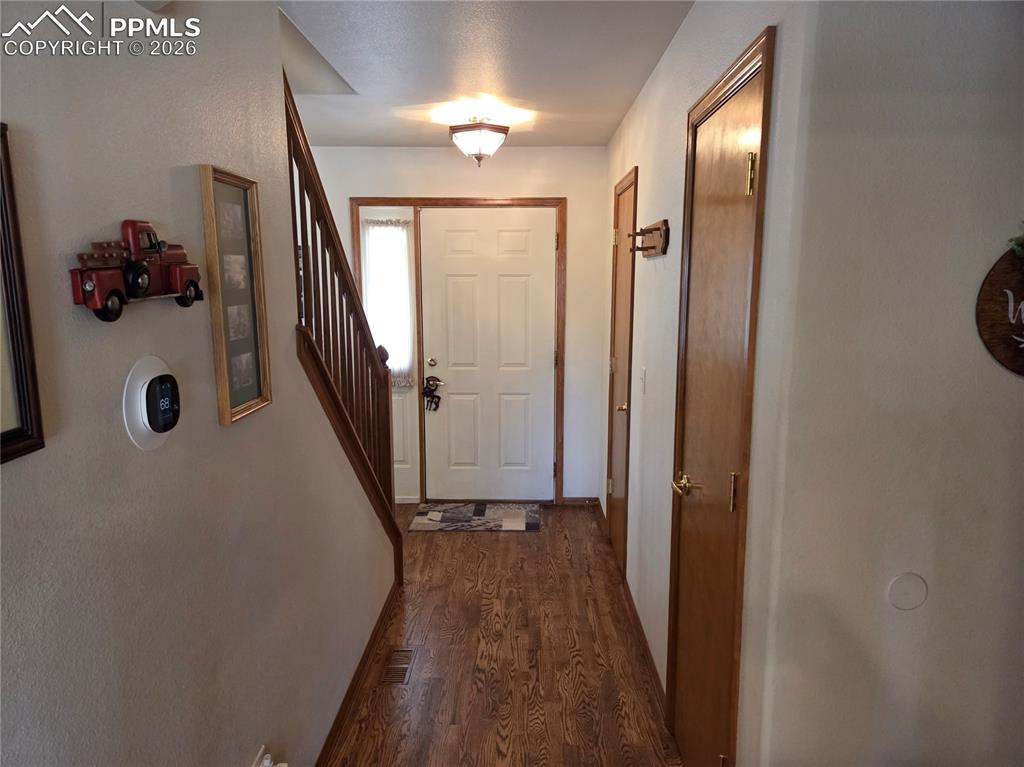 Image 4 of 38: Doorway featuring wood finished floors and stairs
