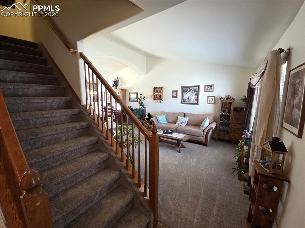 Image 5 of 38: Stairway featuring carpet flooring and arched walkways