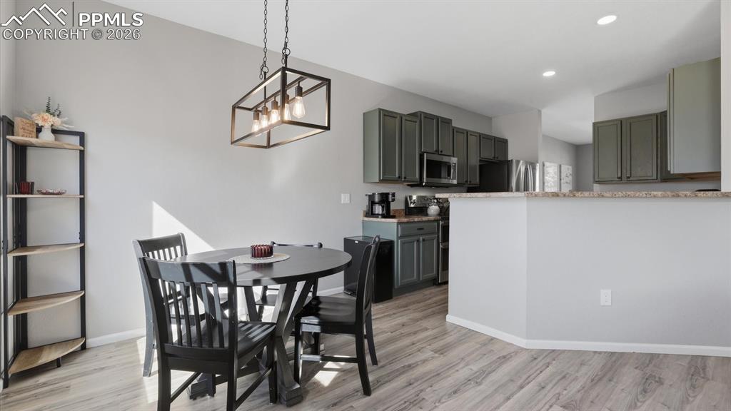Image 13 of 50: Family Room into the Dining Area and Kitchen.
