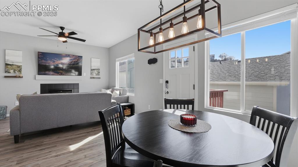 Image 14 of 50: The Dining Area offers a contemporary light fixture and walk out to the sta