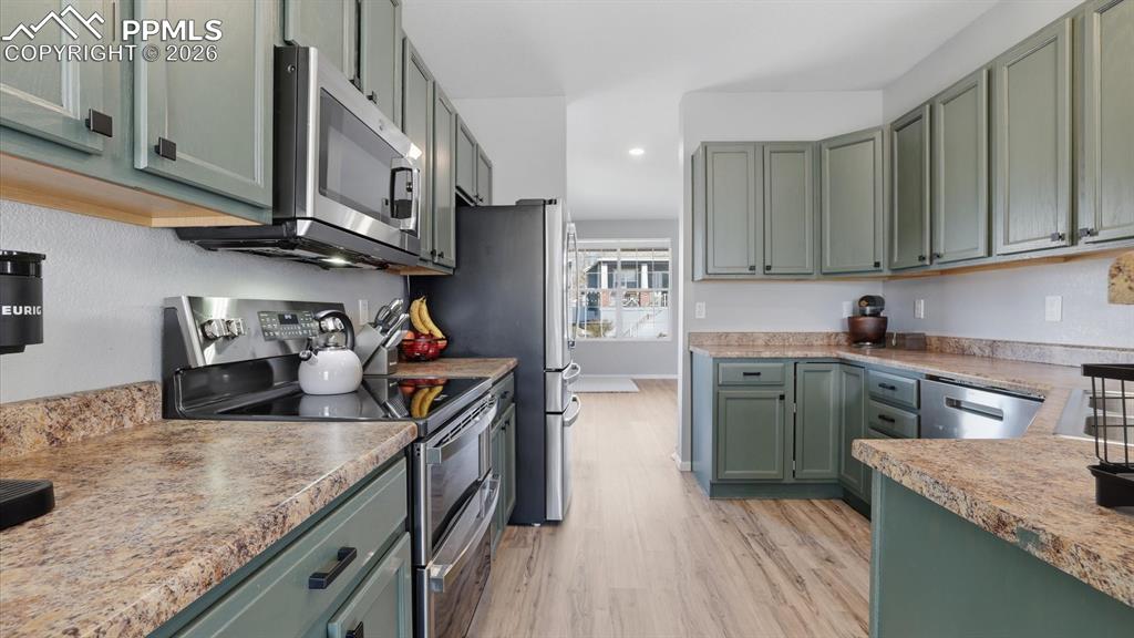 Image 15 of 50: The Kitchen boasts freshly painted wood cabinets with ample counterspace fo