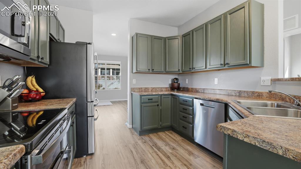 Image 16 of 50: Newer appliances include a dishwasher, smooth top range oven, microwave, an