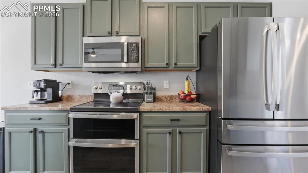 Image 17 of 50: The Kitchen boasts freshly painted wood cabinets with ample counterspace fo