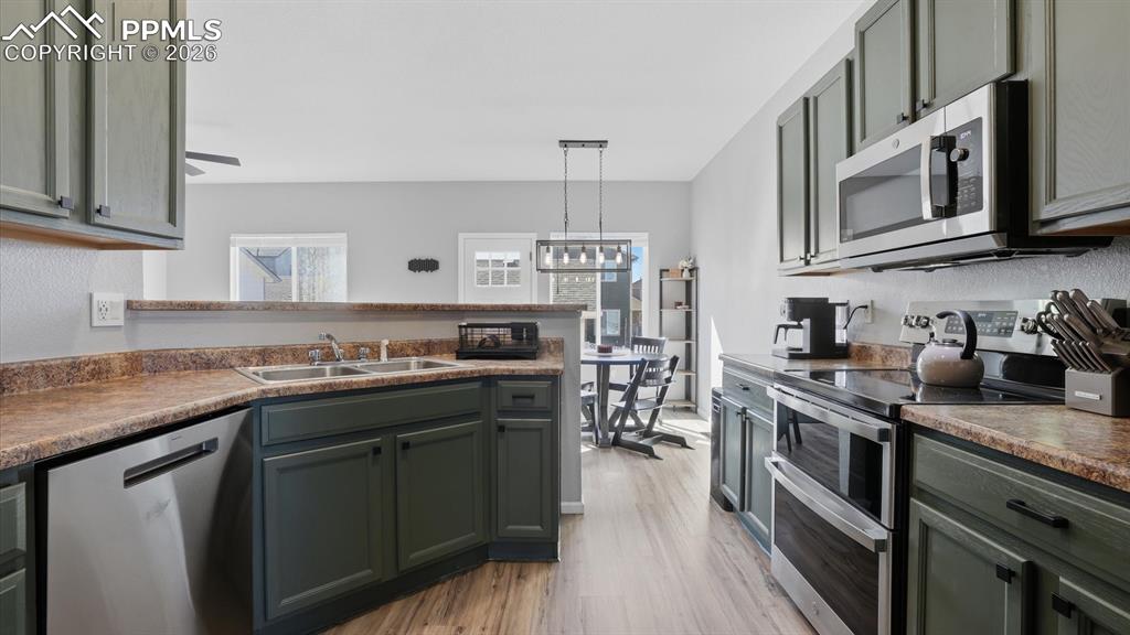 Image 18 of 50: Newer appliances include a dishwasher, smooth top range oven, microwave, an