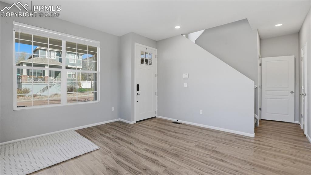 Image 22 of 50: Main Level Laundry Room with built-in shelving and washer and dryer that st