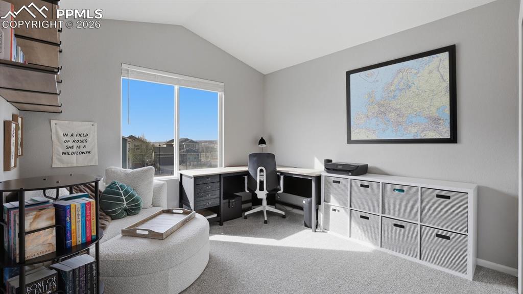 Image 31 of 50: Upper Level Bedroom #3, currently an office, with neutral carpet and large