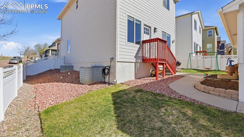 Image 44 of 50: Low maintenance, fenced backyard with walkway to the detached 2-car garage.