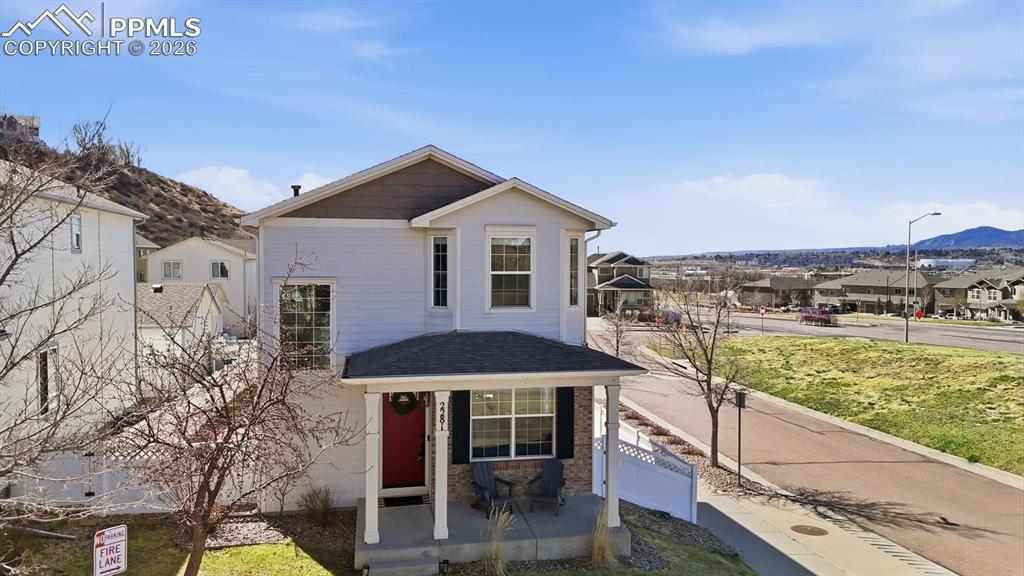 Image 5 of 50: Aerial view o of the front of the home and mountain views.