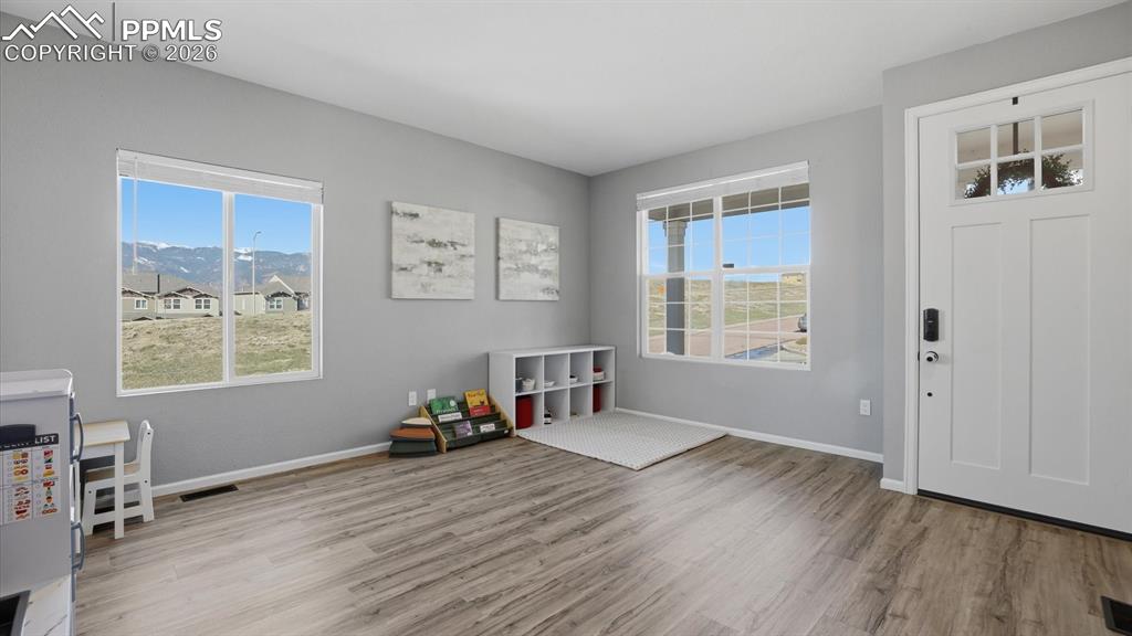 Image 7 of 50: Entry into the Living Room with LVP flooring and large windows with mountai